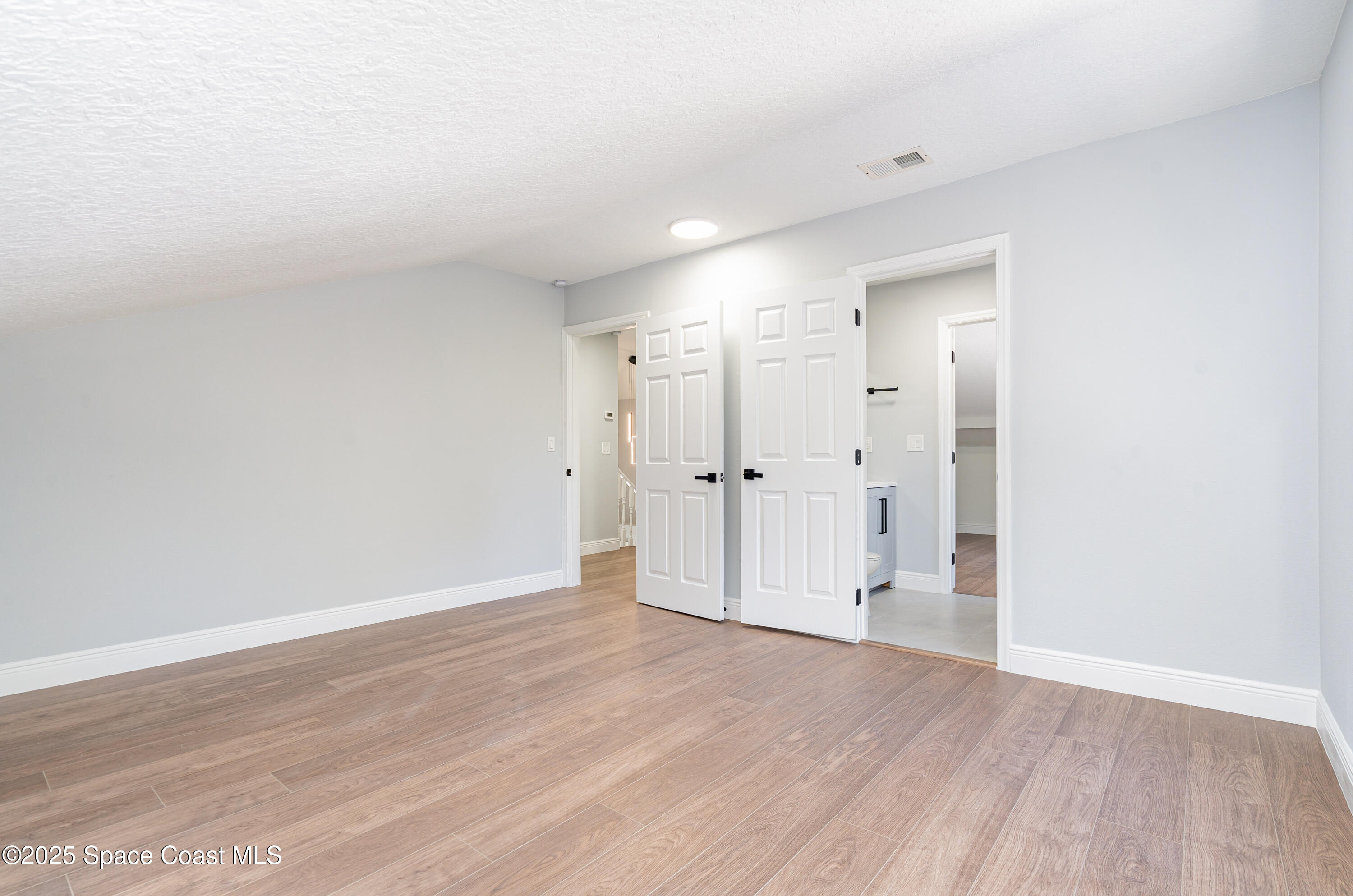 1735 Marywood Road Melbourne, FL 32934 - Photo 13 of 25 a view of empty room with wooden floor