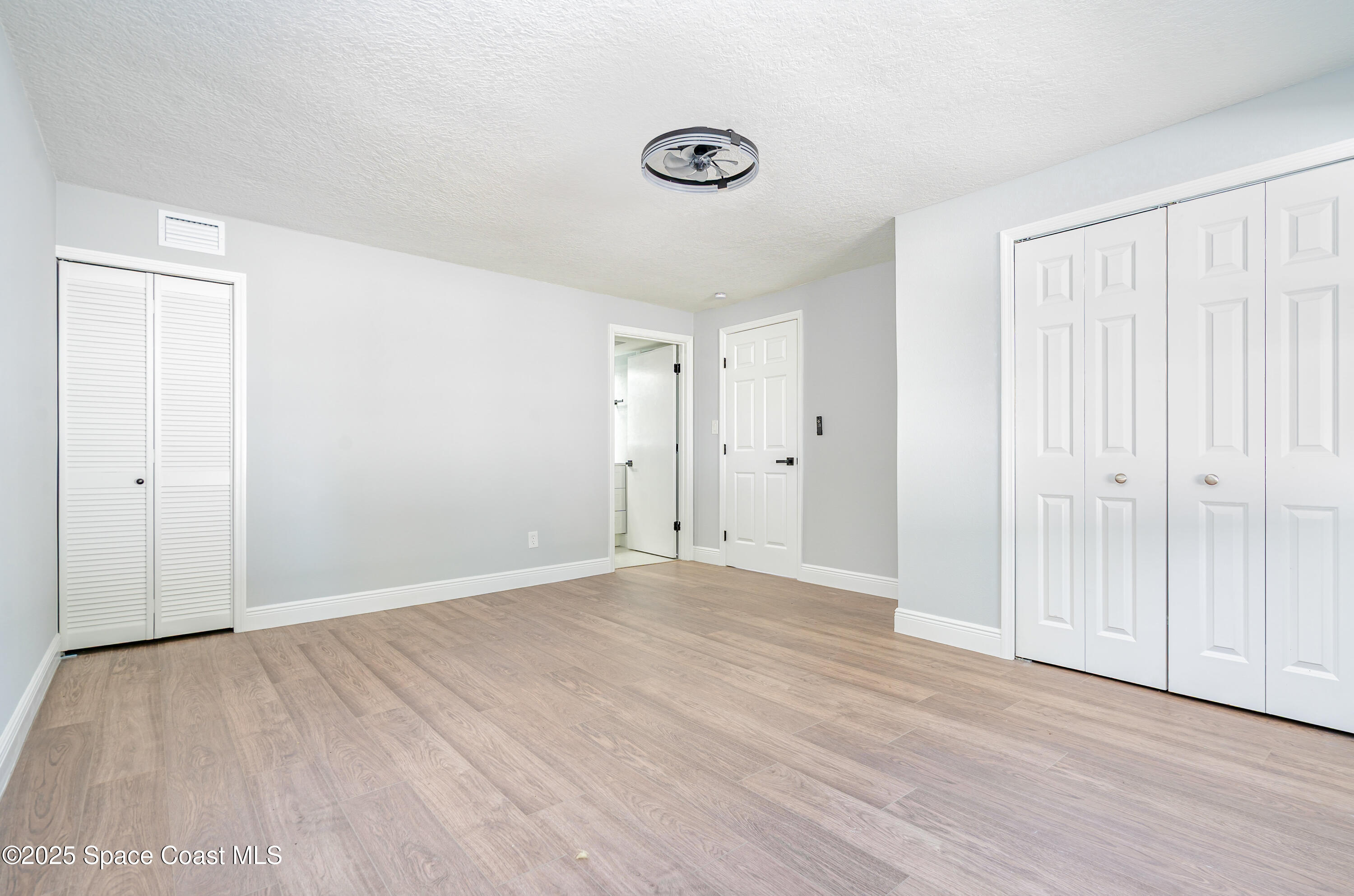 1735 Marywood Road Melbourne, FL 32934 - Photo 17 of 25 a view of an empty room with wooden floor
