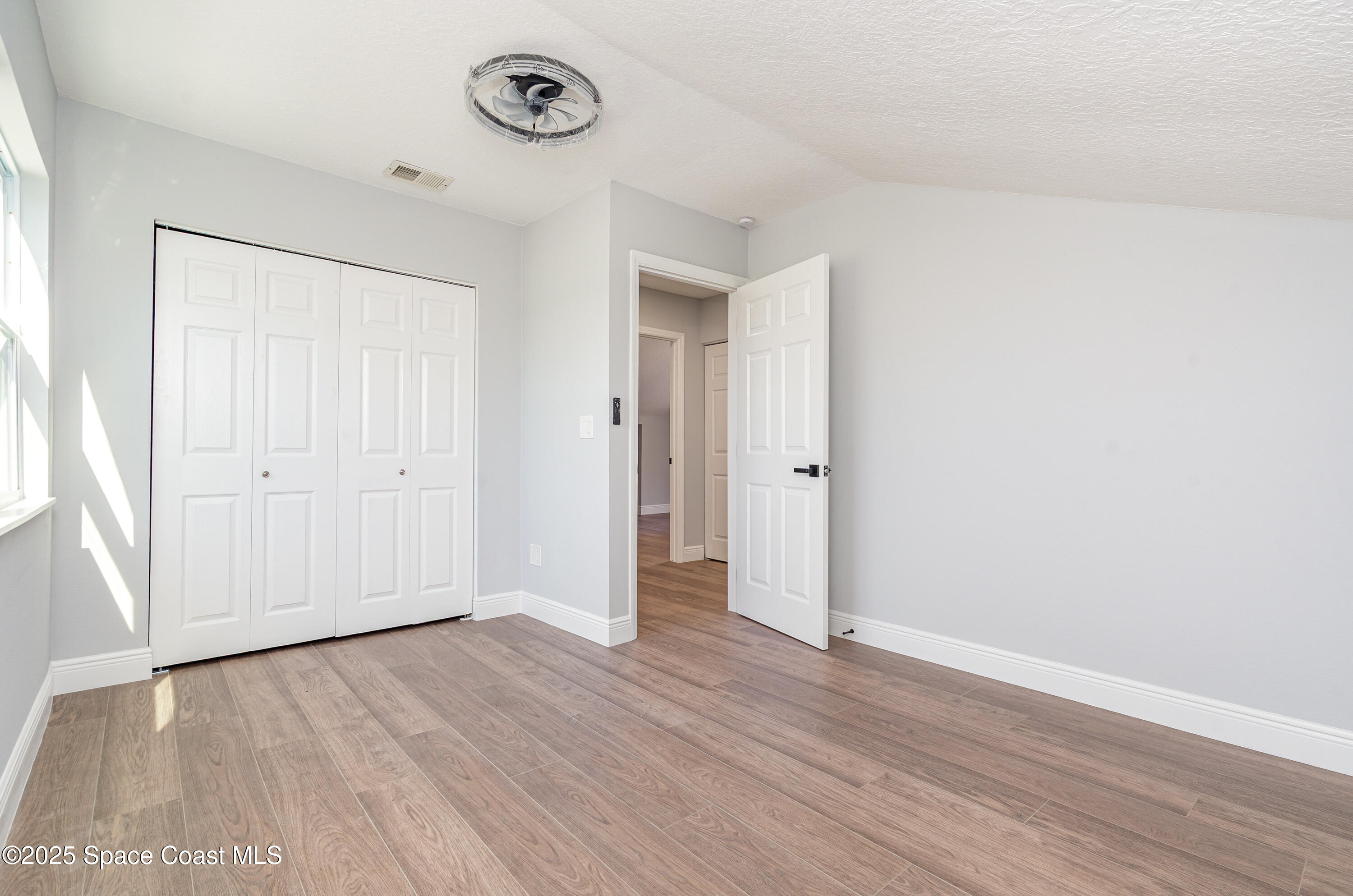 1735 Marywood Road Melbourne, FL 32934 - Photo 19 of 25 a view of an empty room with wooden floor