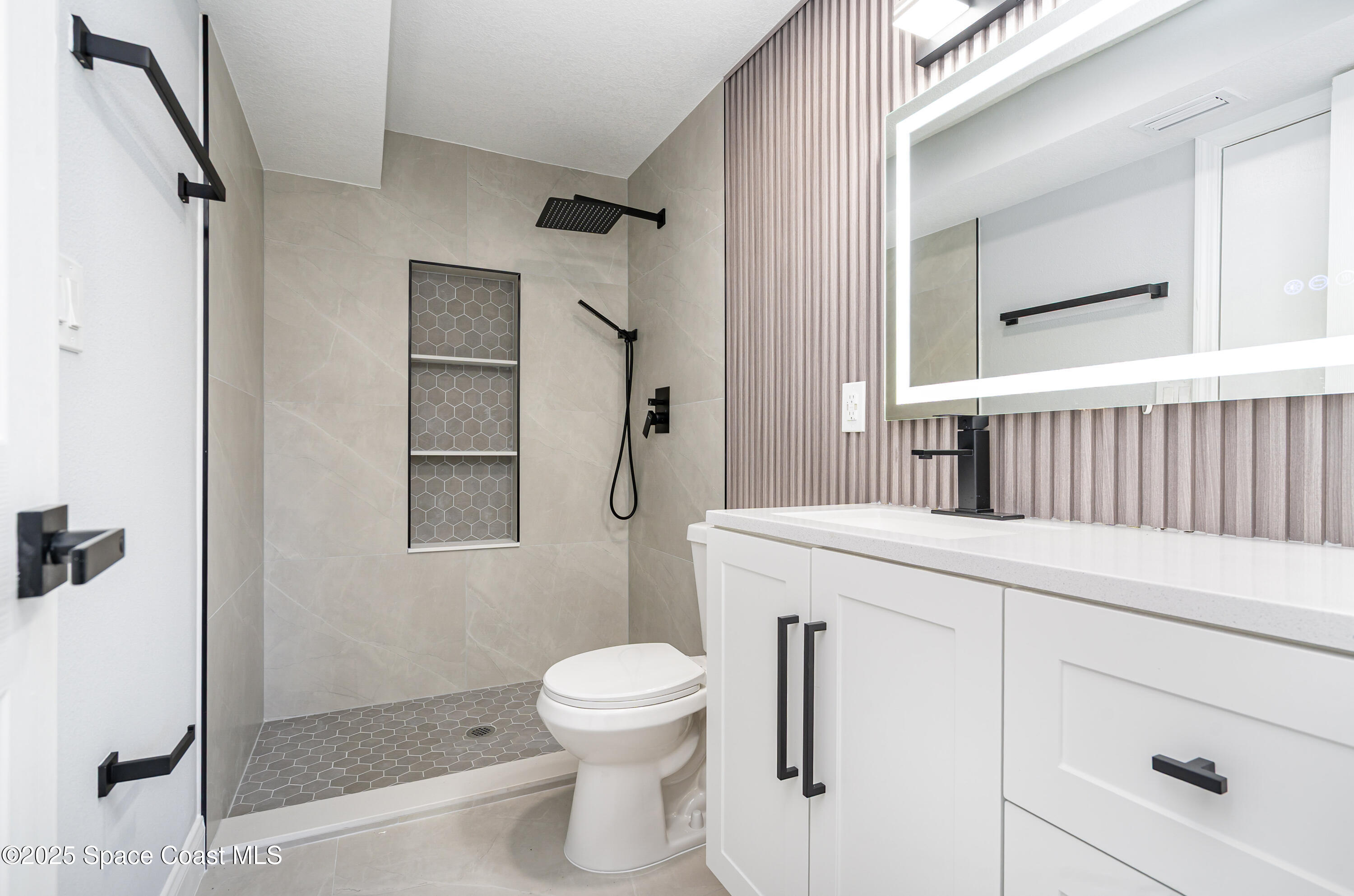 1735 Marywood Road Melbourne, FL 32934 - Photo 20 of 25 a bathroom with a sink a toilet and shower