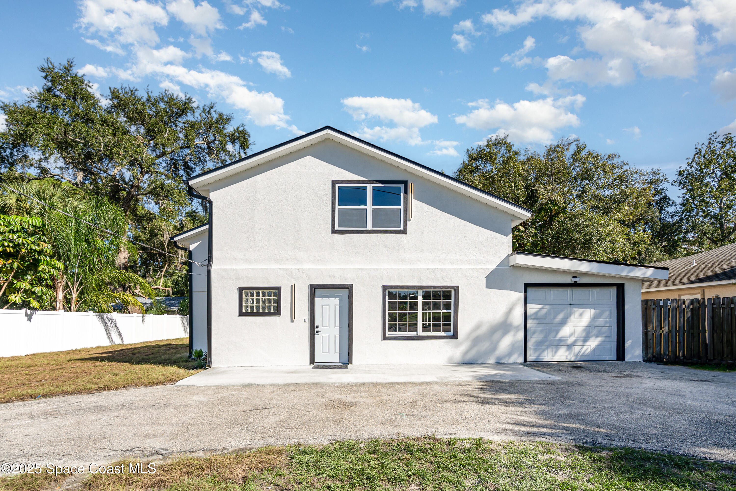 1735 Marywood Road Melbourne, FL 32934 - Photo 2 of 25 a front view of a house with a garden