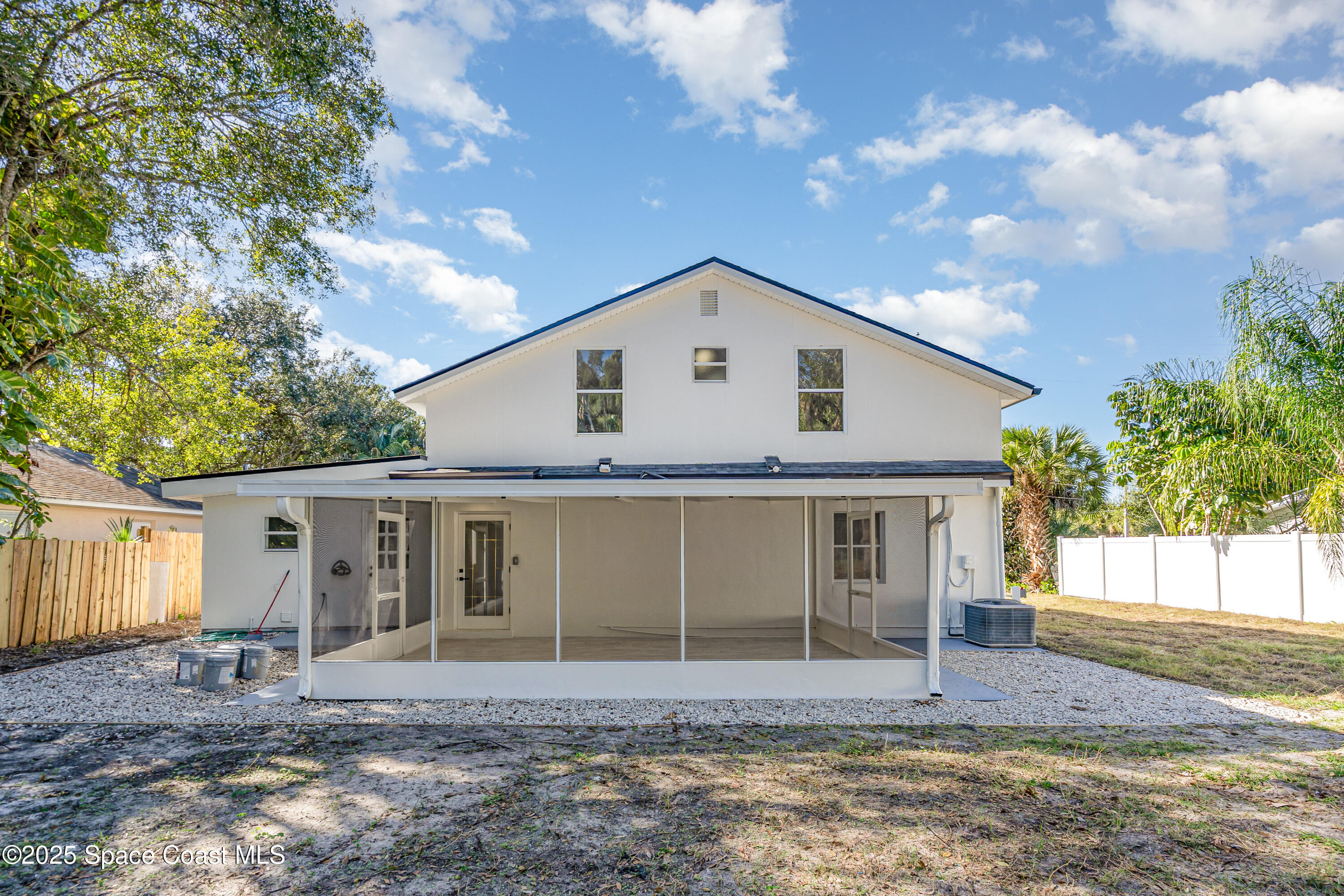1735 Marywood Road Melbourne, FL 32934 - Photo 24 of 25 a front view of a house with a garden and yard