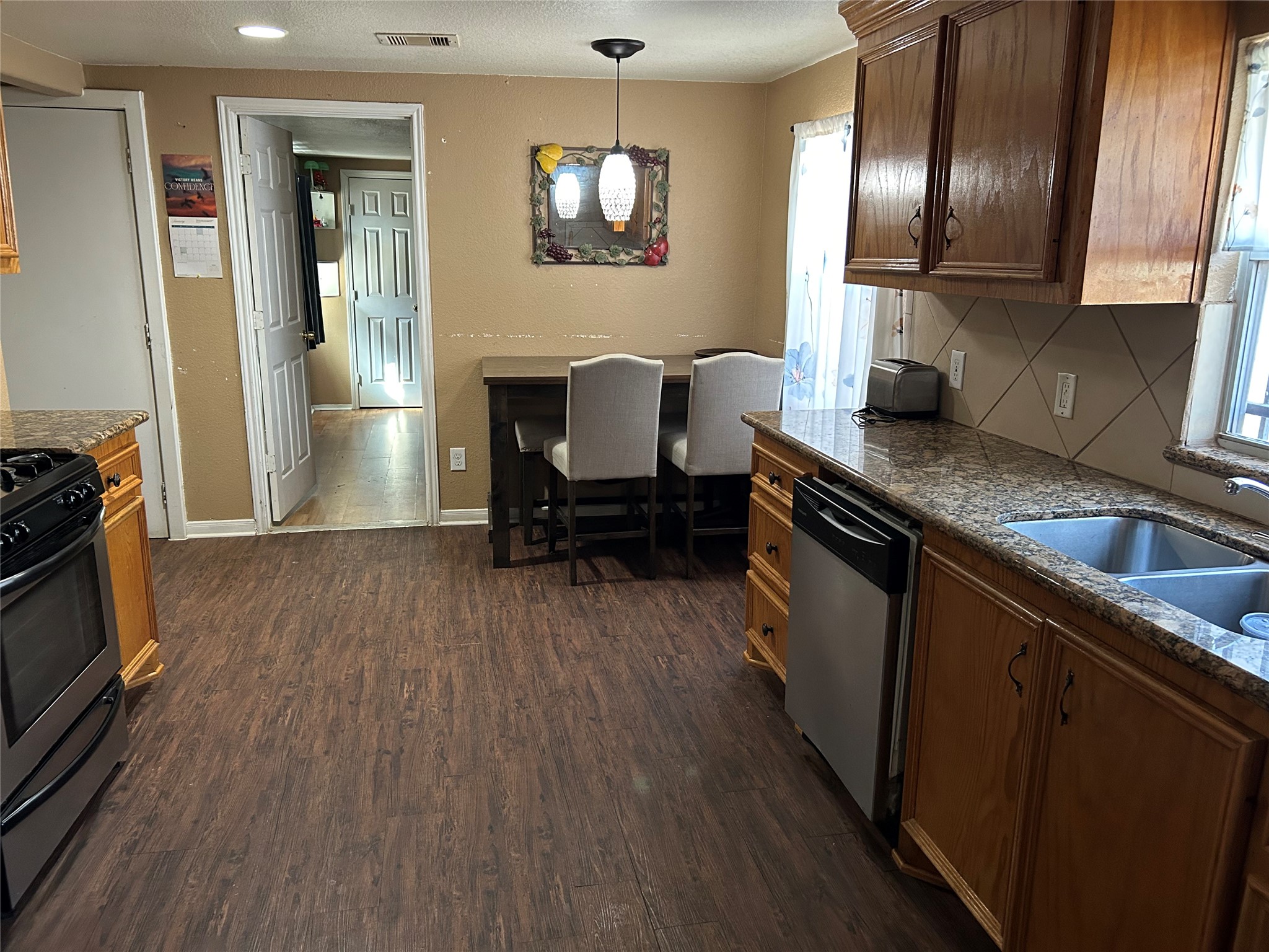 2217 Chew Street Houston, TX 77020 - Photo 11 of 17 a kitchen with granite countertop a sink cabinets and wooden floor