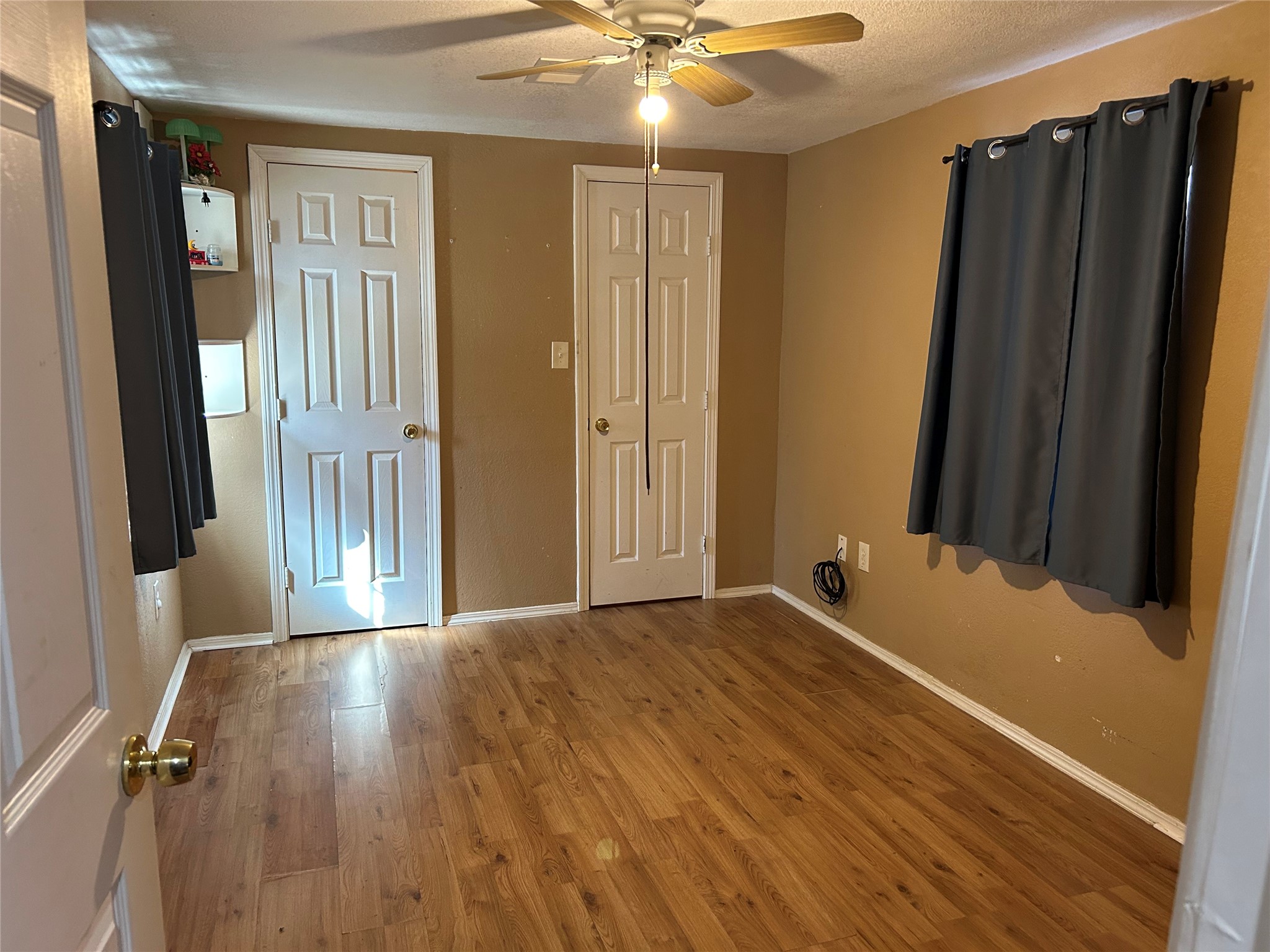 2217 Chew Street Houston, TX 77020 - Photo 14 of 17 a view of a hallway with closet and wooden floor