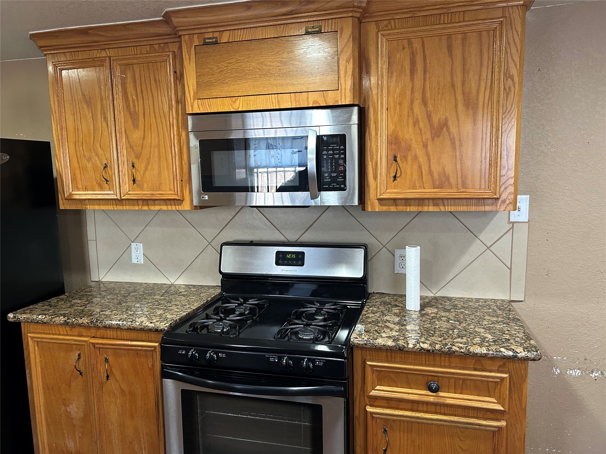 2217 Chew Street Houston, TX 77020 - Photo 9 of 17 a kitchen with granite countertop a stove and a sink