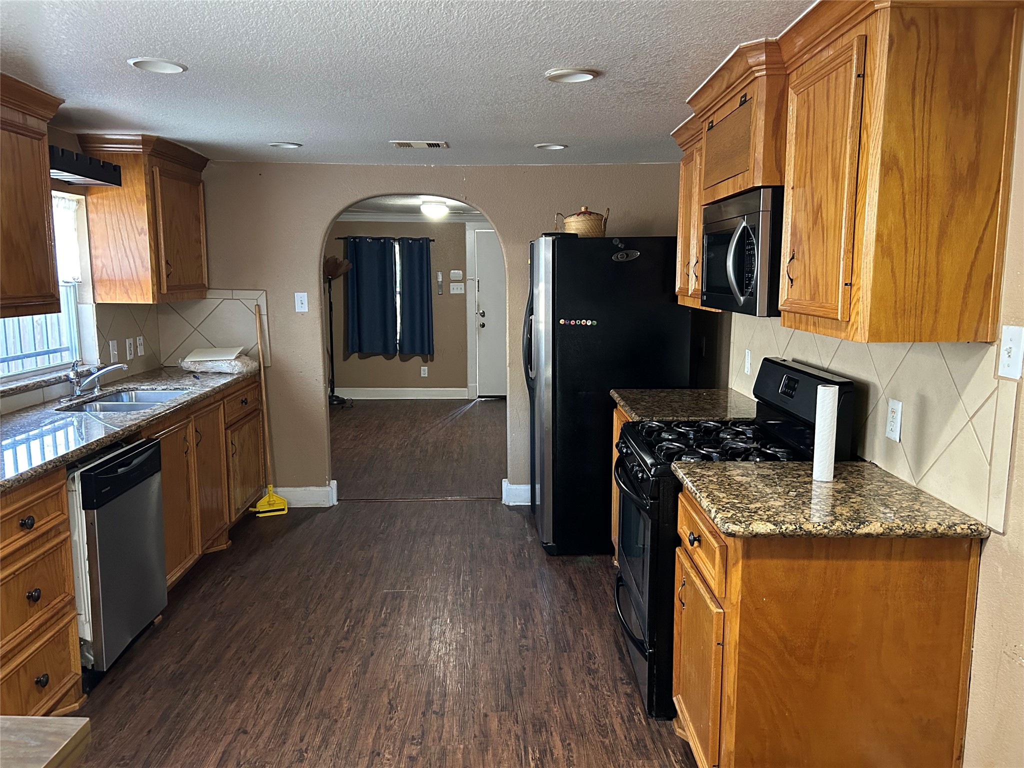 2217 Chew Street Houston, TX 77020 - Photo 10 of 17 a kitchen with stainless steel appliances granite countertop a refrigerator a stove top oven and a sink
