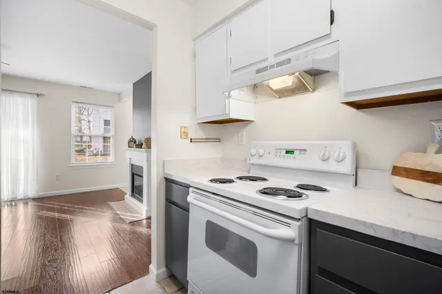 a kitchen with white cabinets and white appliances