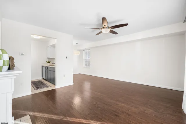 a view of a kitchen with wooden floor and a kitchen space