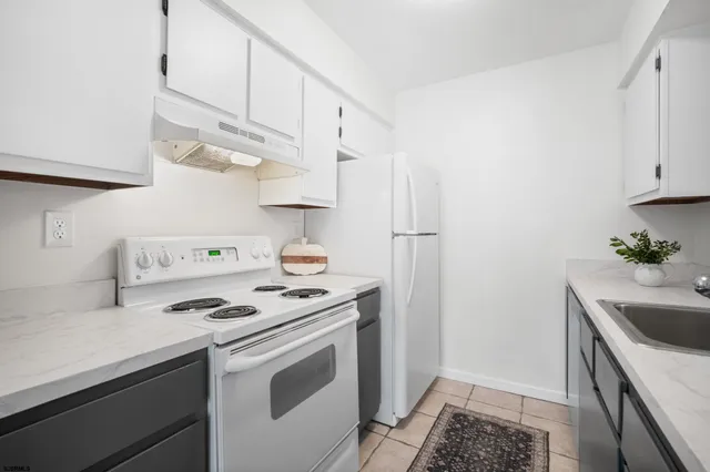 a kitchen with stainless steel appliances a sink a stove and cabinets