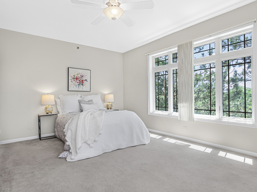 9200 East Prairie Road, Unit 403 Evanston, IL 60203 - Photo 11 of 23 a bedroom with a bed and a large window