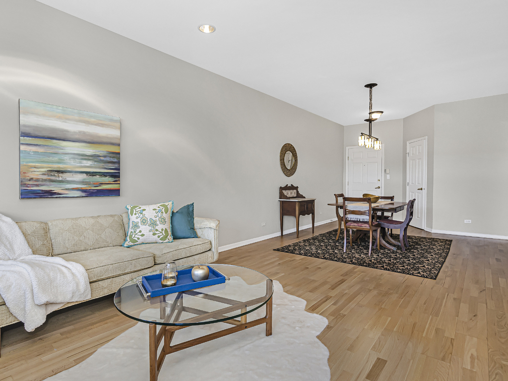 9200 East Prairie Road, Unit 403 Evanston, IL 60203 - Photo 3 of 23 a living room with furniture and a wooden floor