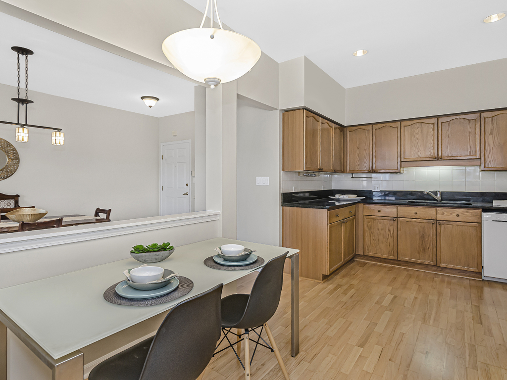 9200 East Prairie Road, Unit 403 Evanston, IL 60203 - Photo 7 of 23 a kitchen with a sink white cabinets and counter space