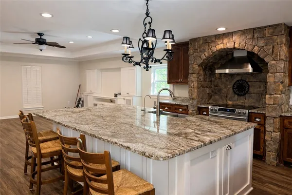 a kitchen with a table a stove and a sink