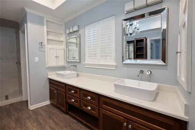 a bathroom with a sink a mirror and a shower