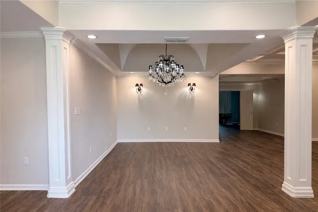 an empty room with wooden floor and window