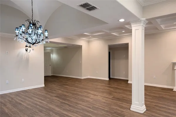 a view of a chandelier in a room with wooden floor