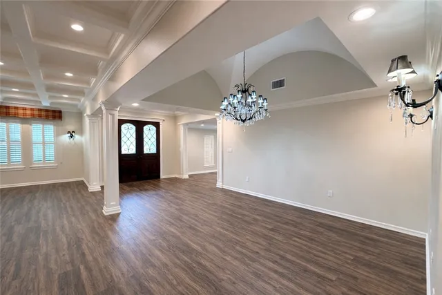 a kitchen with kitchen island granite countertop wooden cabinets and a refrigerator