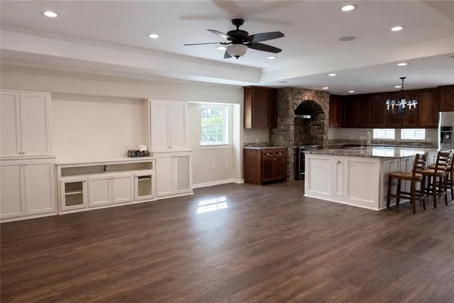 a kitchen with a table a stove and a sink
