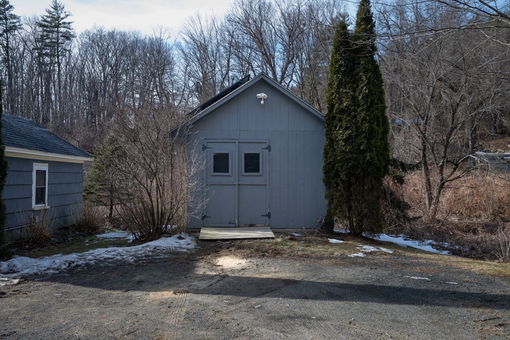 7 Depot Road Williamsburg, MA 01039 - Photo 7 of 29 a view of a house with a yard and garage