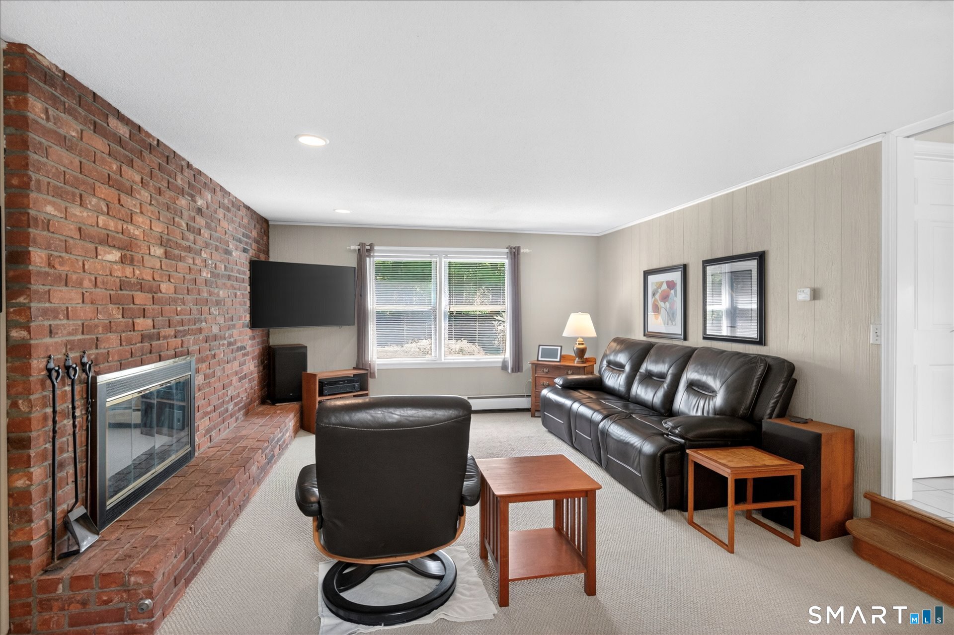 5 Shingle Mill Drive Canton, CT 06019 - Photo 17 of 38 a living room with furniture a fireplace and a flat screen tv