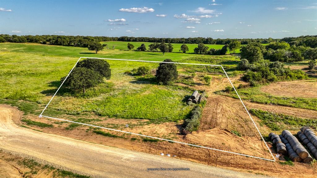 Lot 13-14 Three Quarter Loop Poolville, TX 76487 - Photo 2 of 10 a view of a golf course with a big yard