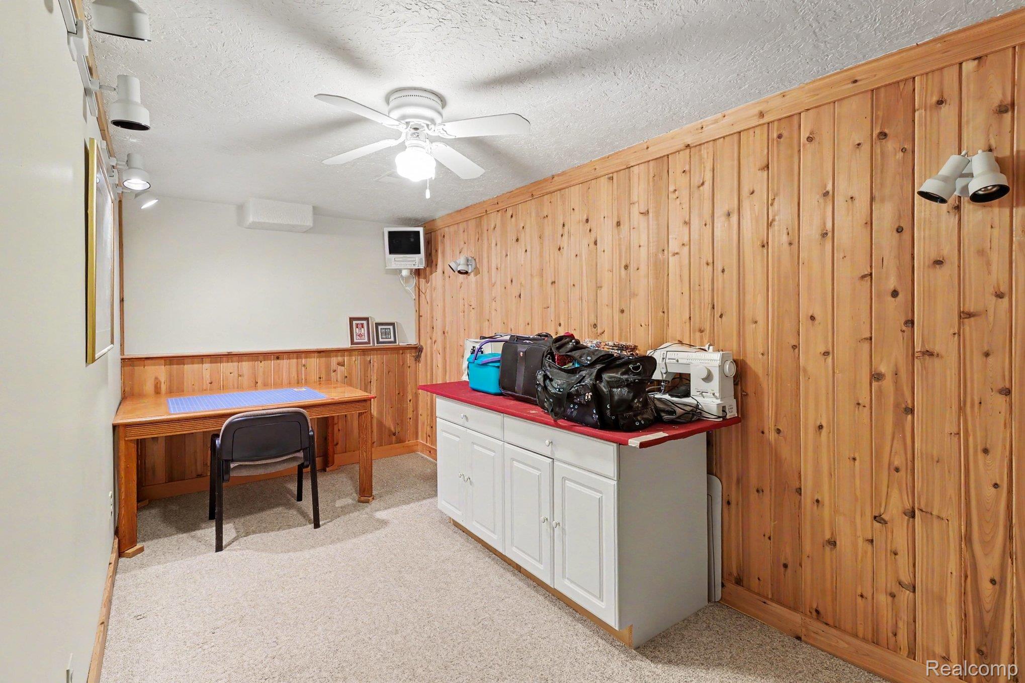 6300 North Raddatz Road Fowlerville, MI 48836 - Photo 31 of 42 Wood-paneled wall accents and built-in cabinetry with red countertop