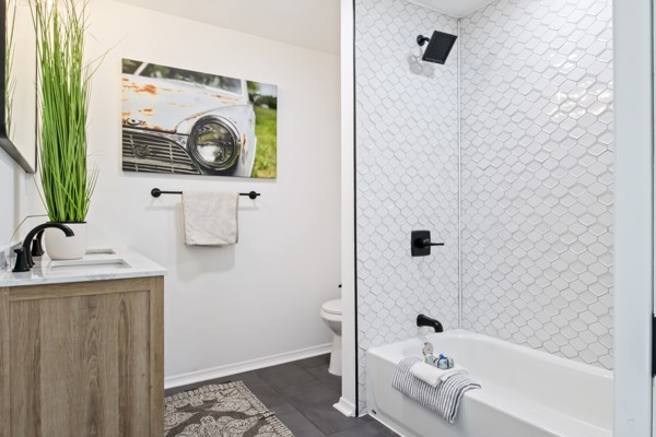 430 Maple Street Madison, TN 37115 - Photo 7 of 16 Brand new bathroom has a dual vanity. The tiled tub/shower gives the vibe of a luxury spa.