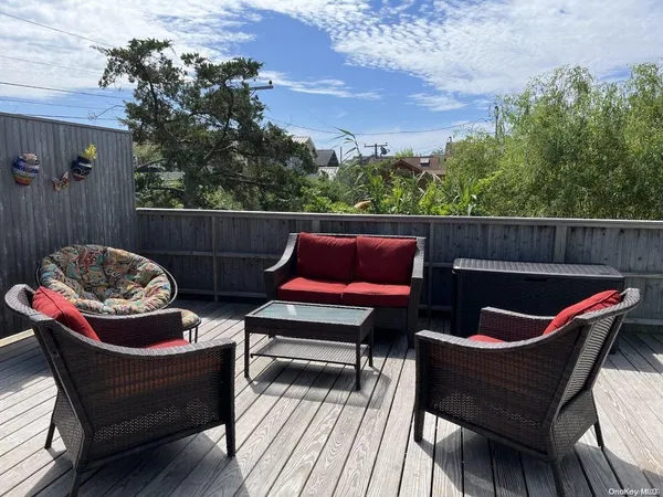 a outdoor sitting area with furniture and wooden floor