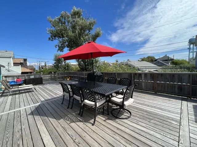 a view of backyard with outdoor seating and wooden floor