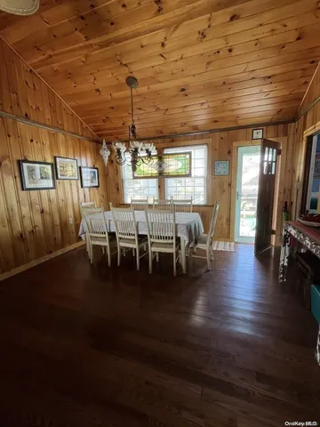 a view of a livingroom with furniture wooden floor and windows