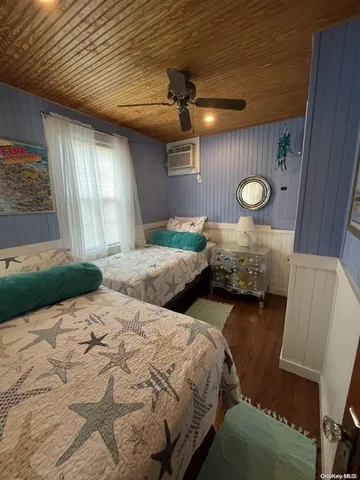 a bedroom with two beds and a large window