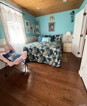 a bedroom with a bed chair and a window