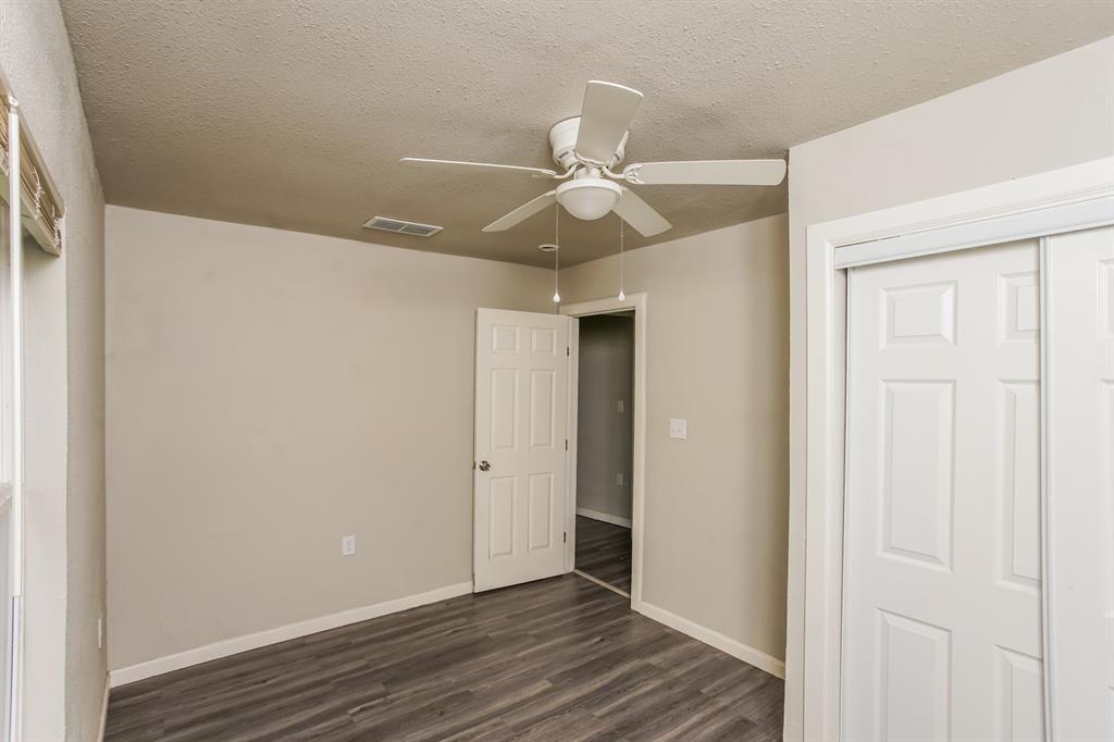 2402 Summer Avenue Waco, TX 76708 - Photo 7 of 15 Room featuring wood-finish flooring, neutral wall paint, and a white ceiling fan with light kit