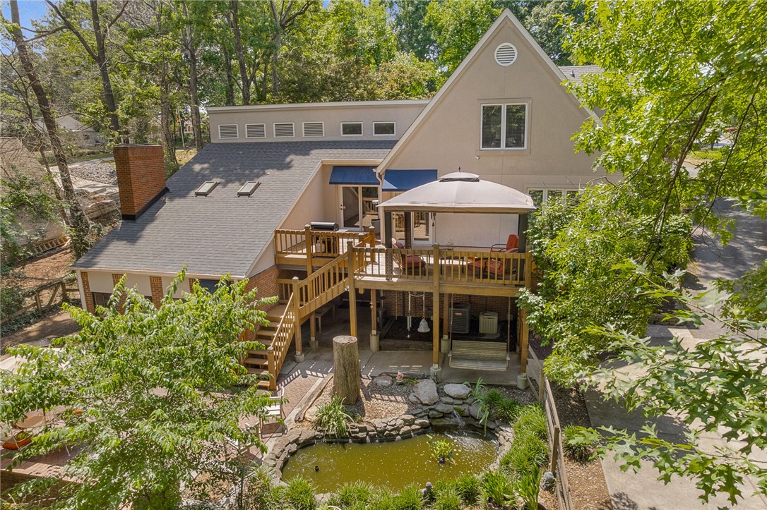 218 Northridge Drive Anderson, SC 29621 - Photo 42 of 50 Discover a multilevel wooden deck with a charming gazebo, overlooking a serene backyard pond and lush landscaping.