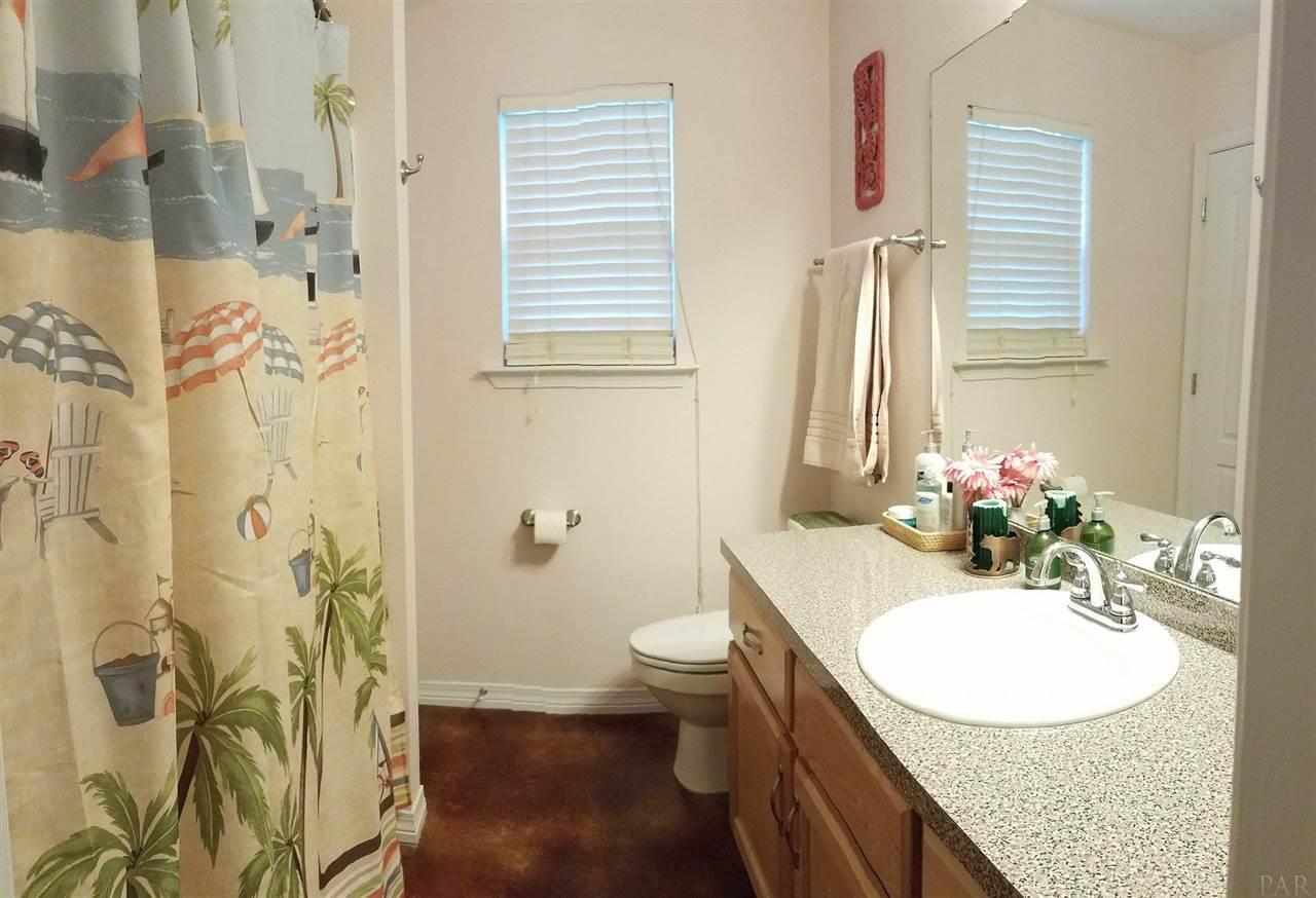 4708 Old Guernsey Road Pace, FL 32571 - Photo 27 of 46 a bathroom with a granite countertop sink toilet and shower