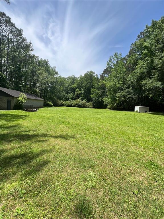 116 Mt Calvary Road Marietta, GA 30064 - Photo 17 of 31 a view of a big yard with a house in the background