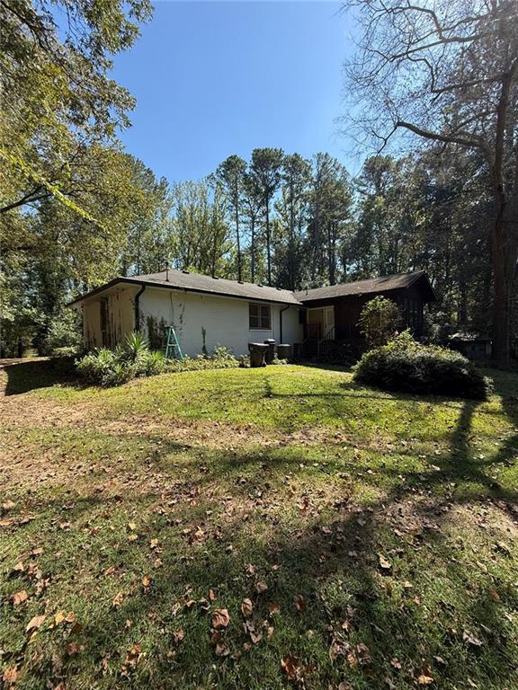 116 Mt Calvary Road Marietta, GA 30064 - Photo 21 of 31 a front view of house with yard and trees in the background