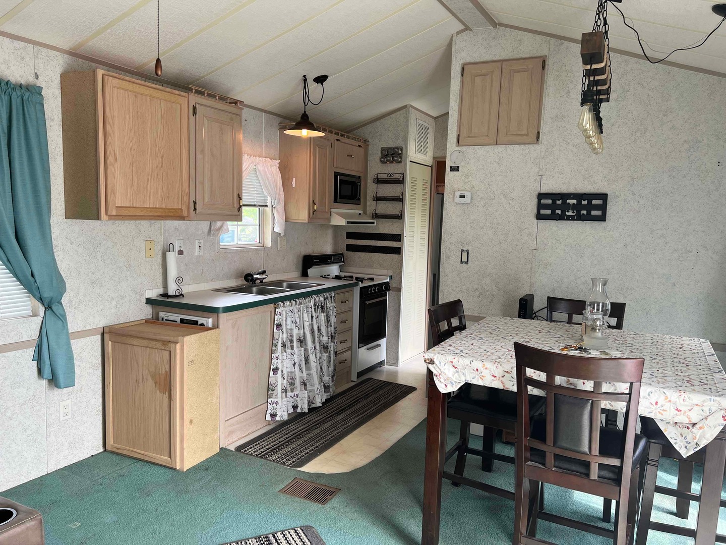 25 Dinosaur Road Wilmington, IL 60481 - Photo 2 of 10 a kitchen with stainless steel appliances kitchen island granite countertop a table chairs in it and wooden floors