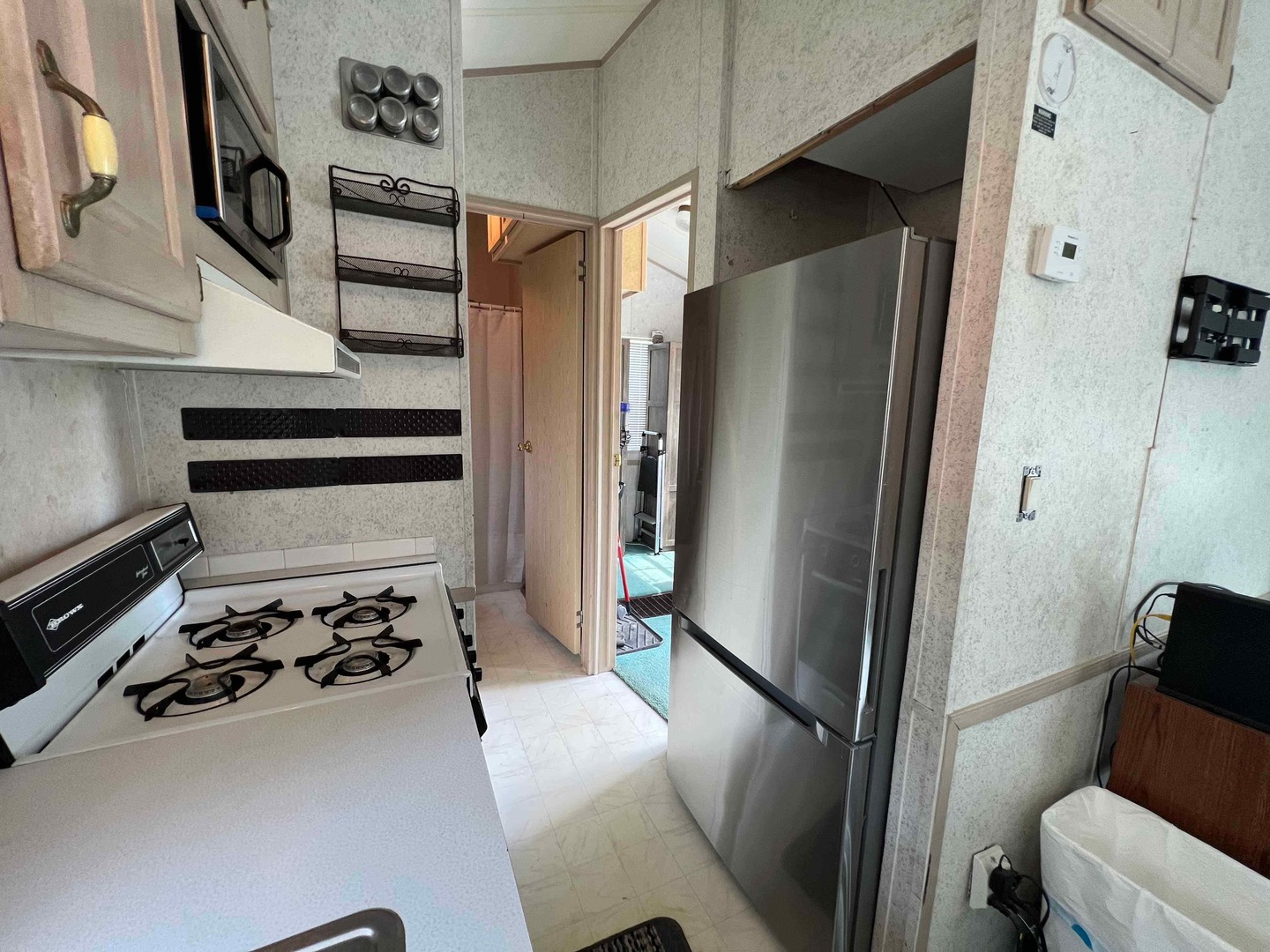 25 Dinosaur Road Wilmington, IL 60481 - Photo 3 of 10 a kitchen with stainless steel appliances a refrigerator and a stove