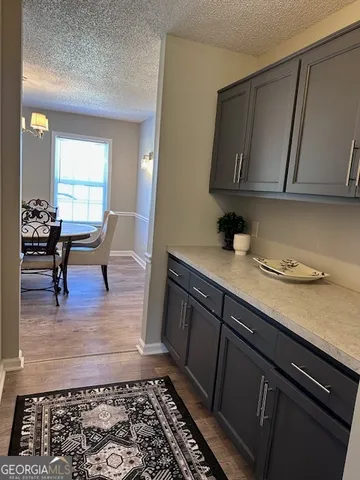a living room with granite countertop furniture a rug and a window