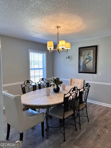 a view of a dining room with furniture and window