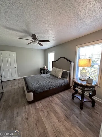 a bedroom with a bed window and a desk