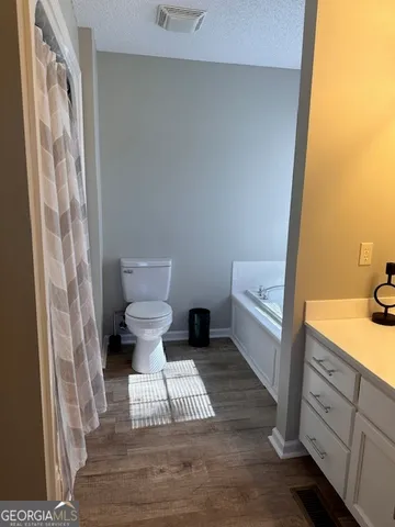 a bathroom with a toilet and a sink
