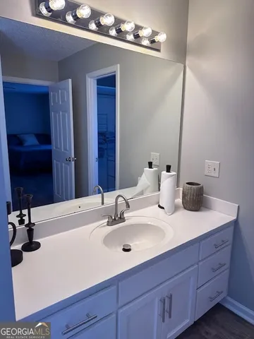 a bathroom with a sink vanity and a mirror