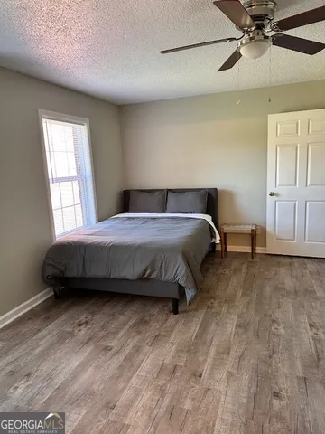 a bedroom with a bed and window