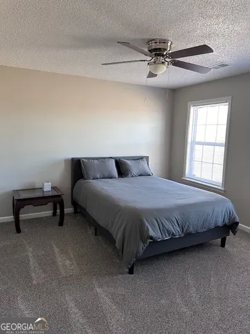 a bedroom with a bed and a table
