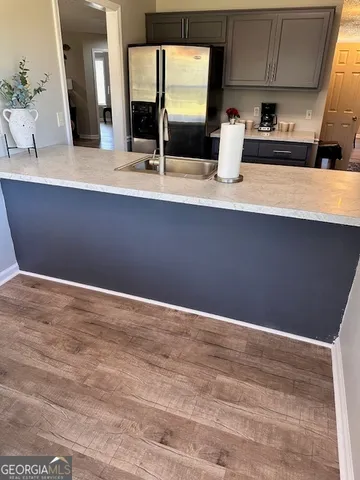 a view of kitchen with granite countertop cabinets and sink