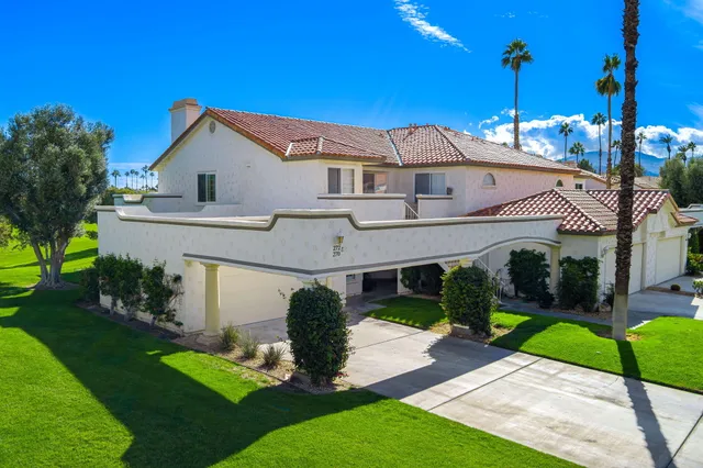 a front view of a house with a garden and porch