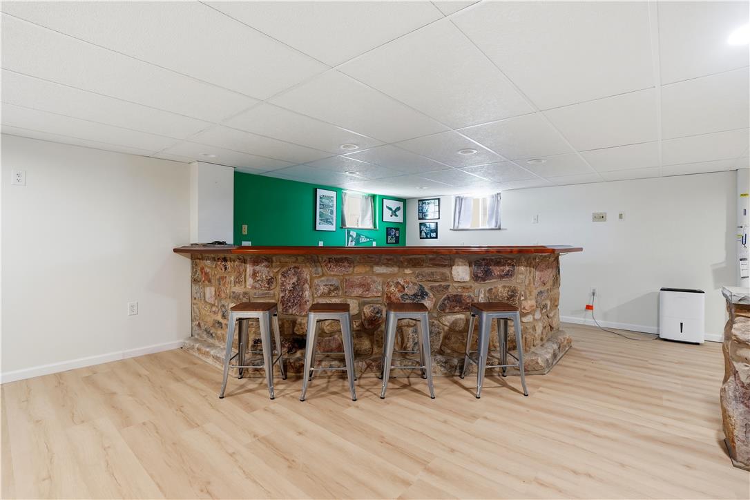2918 Keystone Street Bethlehem, PA 18020 - Photo 22 of 54 A stone-clad bar anchors this inviting recreational space, complete with durable flooring.