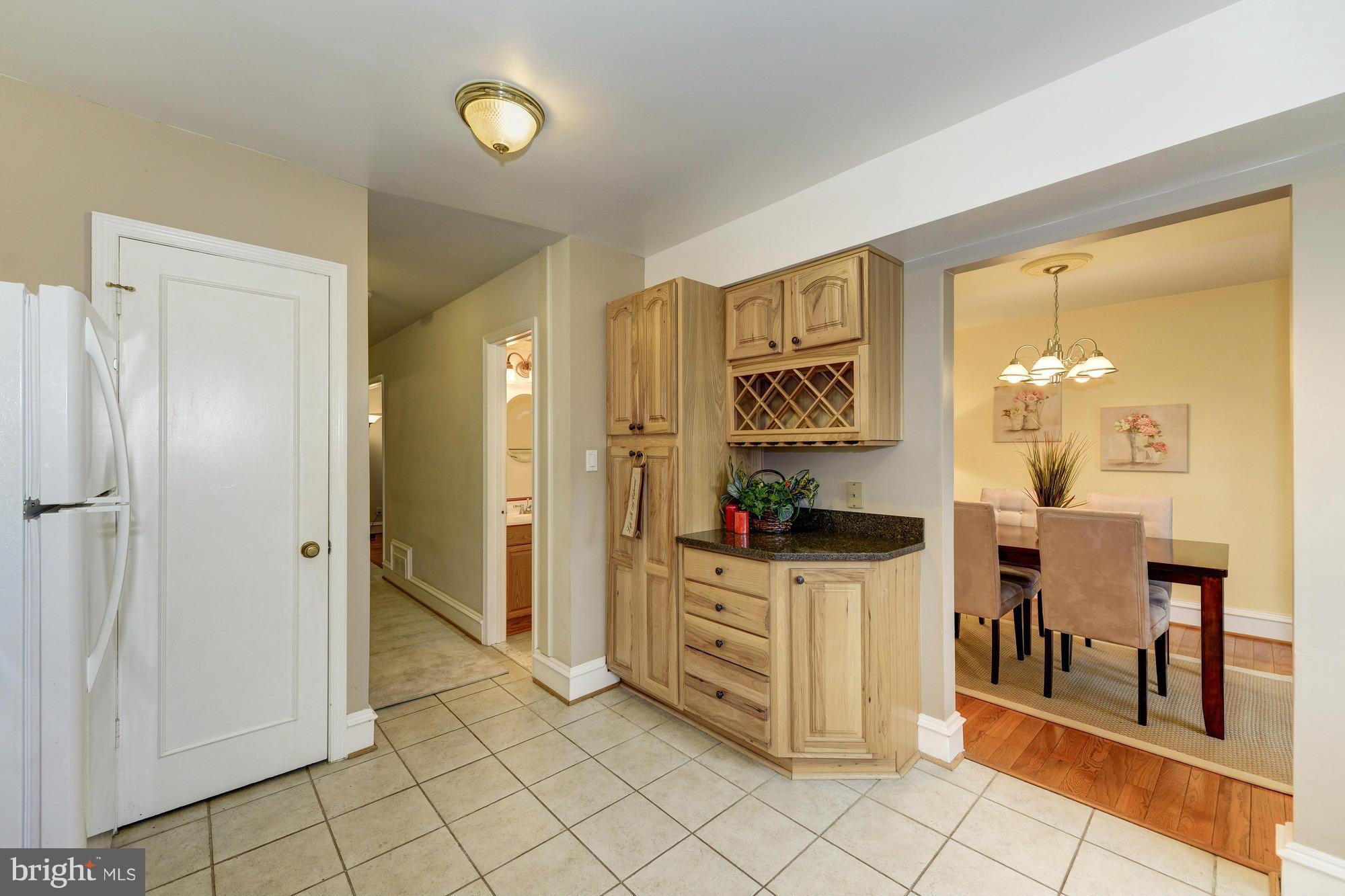 8306 Wickham Road Springfield, VA 22152 - Photo 11 of 29 a view of kitchen with furniture and wooden cabinets